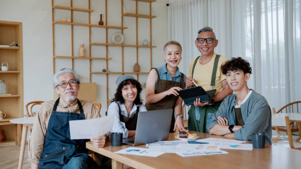 istock Portrait of team Entrepreneurs  at the Conference Table Have Discussions, Solve Problems, Use Digital Tablet, Laptop, Share Documents with Statistics, Charts. 2154614554