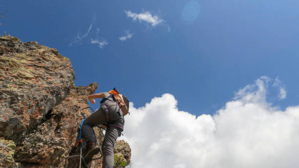 istock Climbers ascend cliff on via ferrata 2154614640