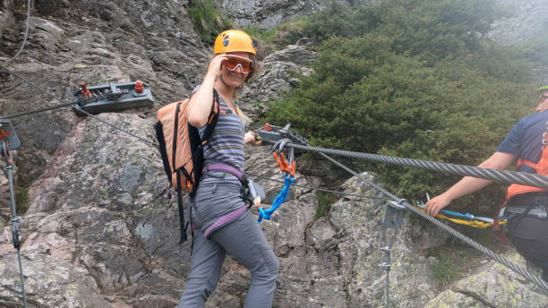 istock Climbers ascend cliff on via ferrata 2154615574