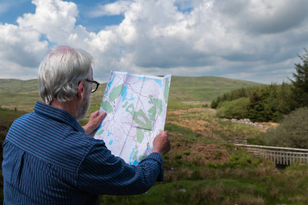 istock Rear view of a senior man looking at a map 2154617039