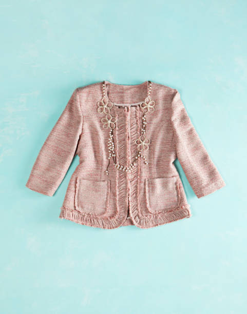 Fashionable pink blazer jacket on turquoise colored  background