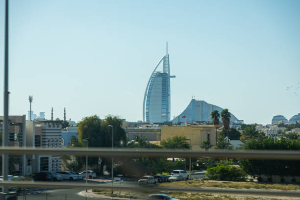 Dubai, UAE - May 14, 2024: Burj Al Arab and Jumeirah Beach Hotel with surrounding buildings in Dubai