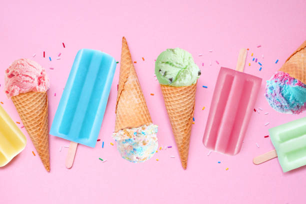 istock Colorful pastel summer ice cream cone and popsicle  flat lay on a soft pink background 2154618115
