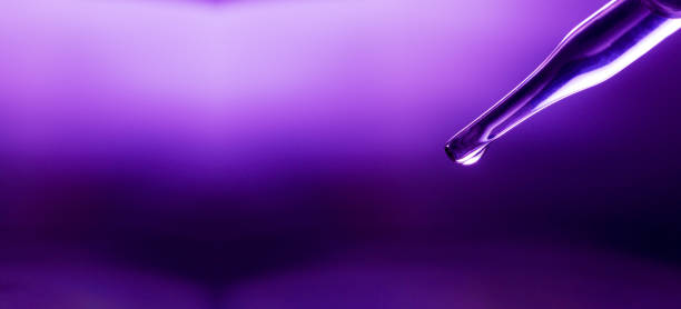 Water droplets falling from a syringe-shaped dropper
