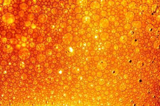 istock Yellow drink bubble texture close-up,Beer Background Ice Cold Pint With Water Drops Condensation,Golden yellow water drops. Nature collection. 2154618377
