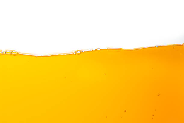 istock orange juice texture isolated white background,orange juice texture isolated white background 2154618406