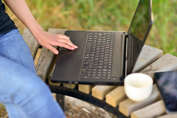 Close-up photos of businesswoman running her business from computer and tablet in open area