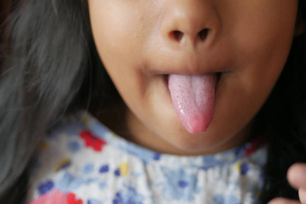 Cute kid sticking his tongue out in studio