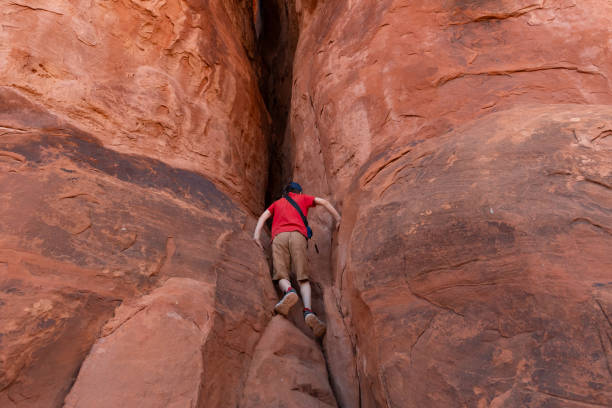 istock Boy Climbing Rocks in Arches National Park, Utah 2154624666