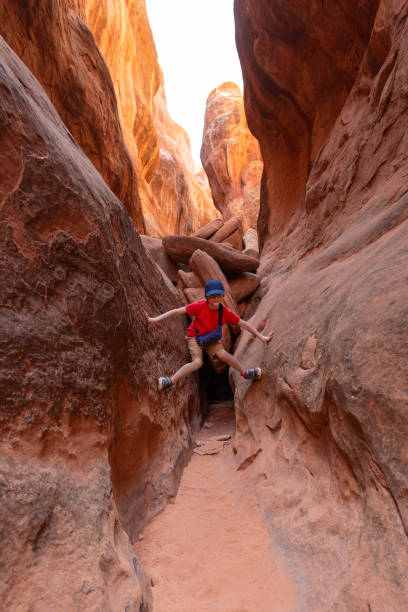 istock Boy Climbing Rocks in Arches National Park, Utah 2154624668