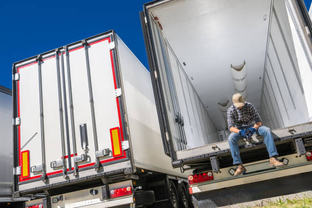 istock Devastated Trucker Sitting on Semi Truck Trailer Bed 2154629190