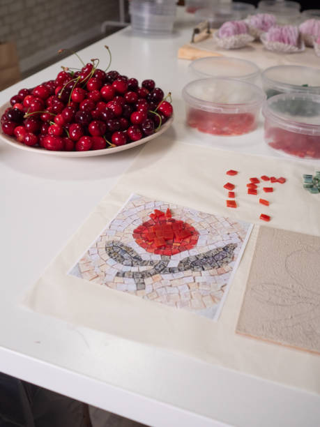 A vertical close-up flat lay captures a mosaic workshop table in all its vibrant detail.