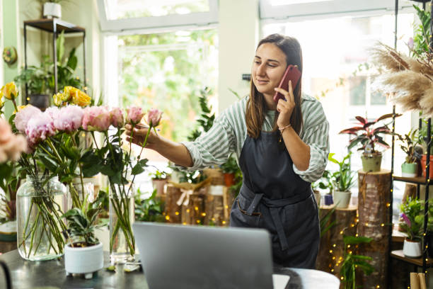 istock Woman Managing Flower Shop Digitally 2154632151