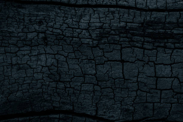 istock cracked wood black background or texture 2154637460