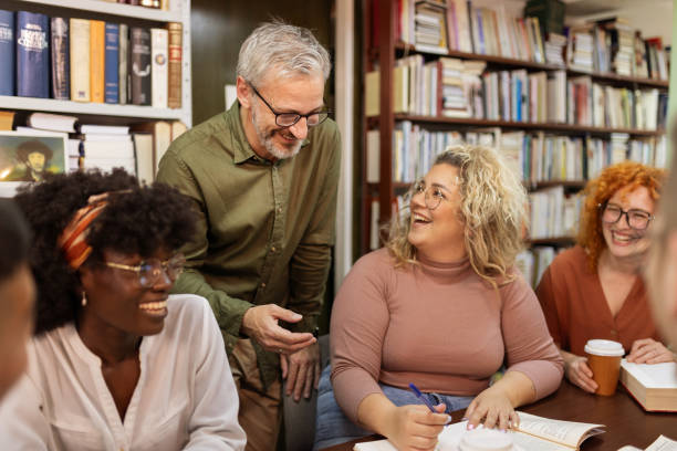 istock College Students Working in Library Being Helped by Tutor 2154637628