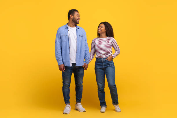 istock Man and Woman Standing Next to Each Other, Holding Hands 2154637880