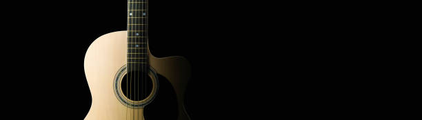 istock acoustic guitar on black background 2154642657