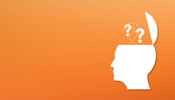 istock Human head with question mark on orange background. Mental health and problems with memory. 2154643287