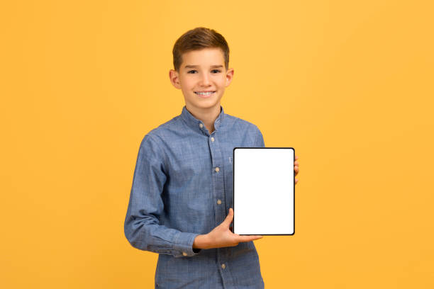 istock Smiling Teen Boy Holding Digital Tablet With Blank White Screen 2154643427