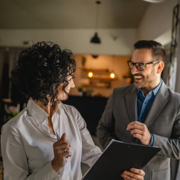 istock Colleagues stand in cafe woman hold document and smile with man 2154643557