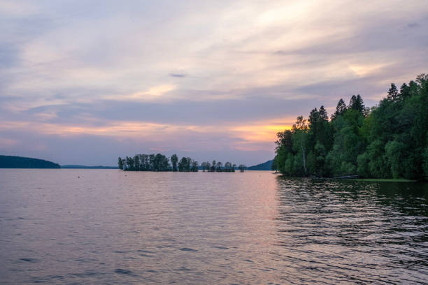 istock Landscape, lake shore and trees in spring. Beautiful sky with sunset. 2154643584