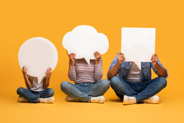 istock Thoughts Diversity. Black Father, Mother And Son Hiding Behind Empty Speech Bubbles 2154645085