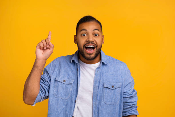 istock Idea Concept. Excited Black Man Pointing Finger Up And Looking At Camera 2154645102