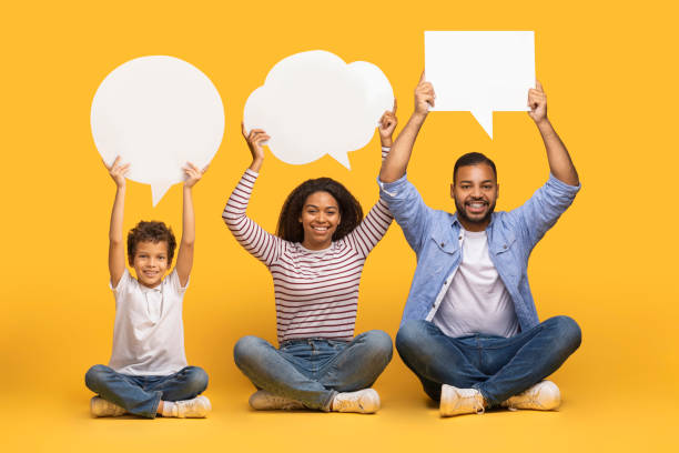 istock Diverse Opinions. Black Family Of Three Holding Different Empty Speech Bubbles 2154645152