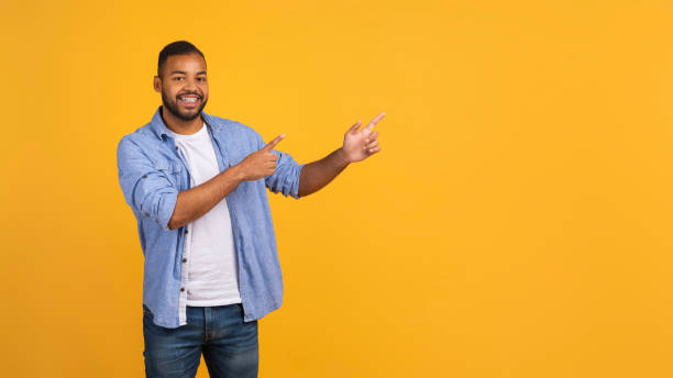 istock Look There. Black Man Pointing Aside At Copy Space With Two Hands 2154645176