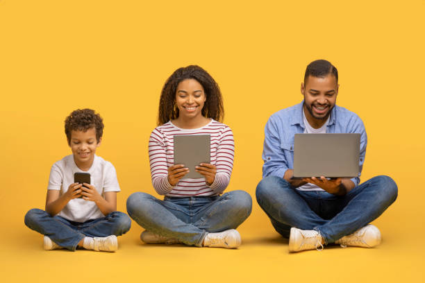 istock Family Gadgets. Black parents and little son using different electronic devices 2154645180