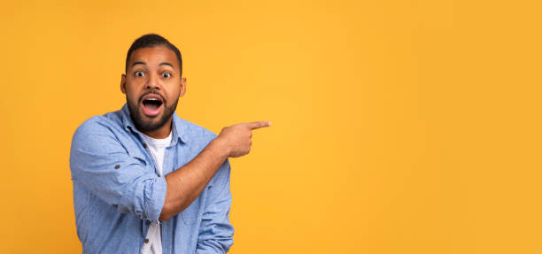 istock Shocking Offer. Emotional Black Man Pointing At Copy Space With Hand 2154645191