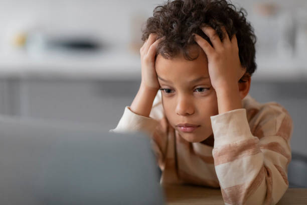 istock Homeschooling Difficulties. Upset Black Boy Using Laptop At Home And Touching Head 2154646453