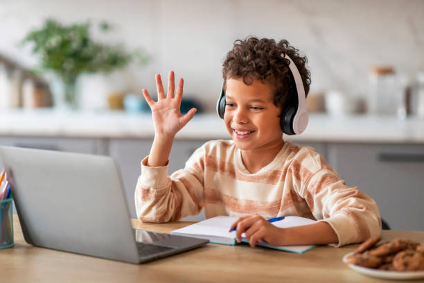 istock Black Boy Having Online Lesson, Making Video Call On Laptop At Home 2154646514