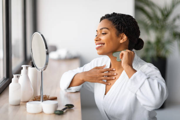 istock Beautiful young black woman doing neck massage with gua sha tool 2154649546