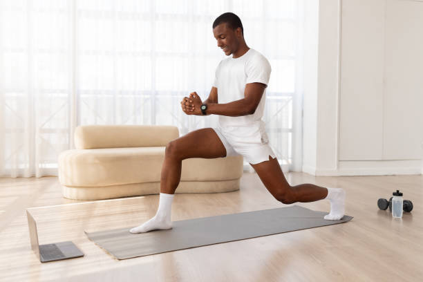 istock Man doing a lunge in a bright room 2154649959