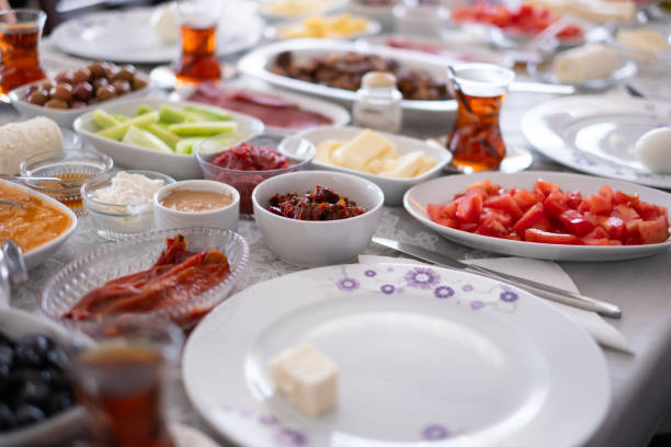 Traditional Turkish breakfast image. There are cheese varieties, jam varieties, olive varieties, tomatoes, pastries, dried meats, and fruits. stock photo