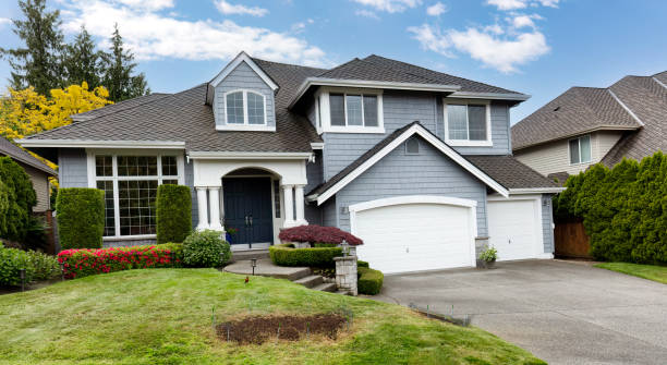 istock Front yard lawn repaired with new grass seed and netting to protect new growth with home in background during spring 2154652536