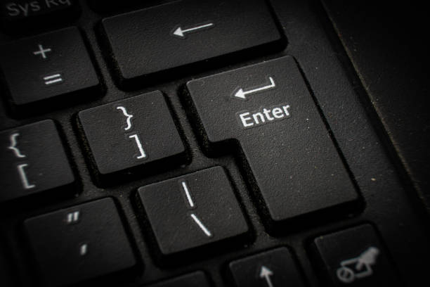 A detailed close-up view of a red enter button on a keyboard, showing the keys texture and design.