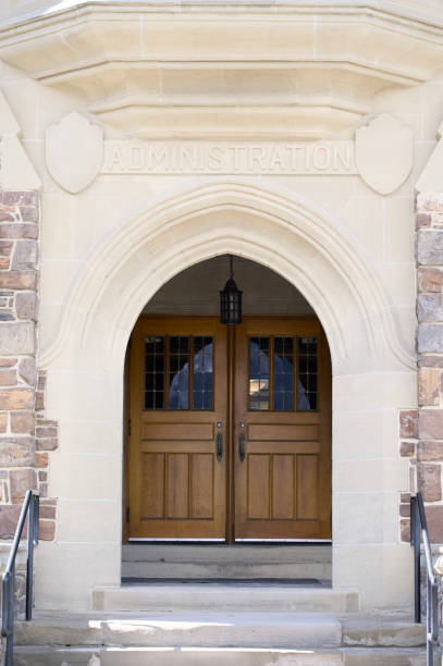 istock Engraved administration sign over stone arch entrance doorway 2154660908