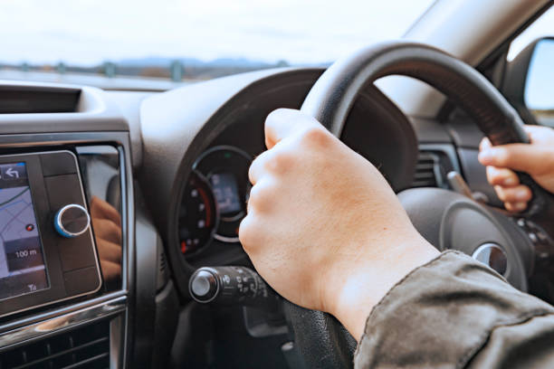istock A driver holding the steering wheel of a moving car 2154662705