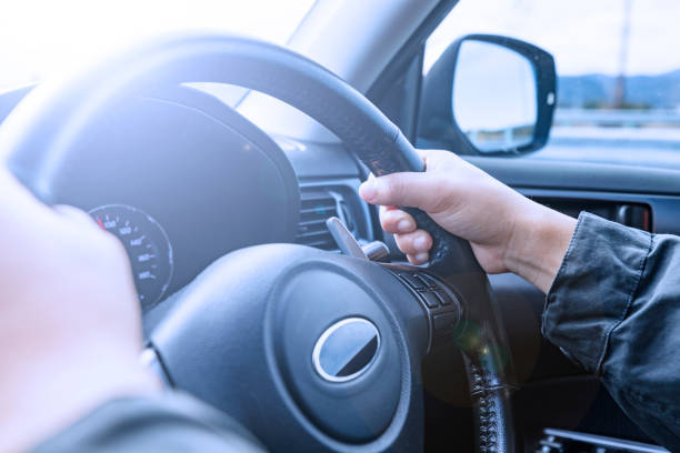 istock A driver holding the steering wheel of a moving car 2154662827