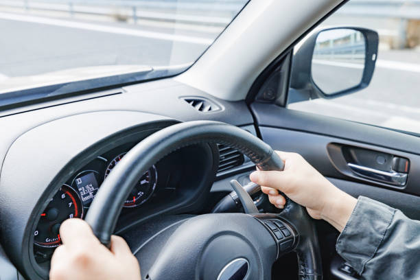 istock A driver holding the steering wheel of a moving car 2154662910