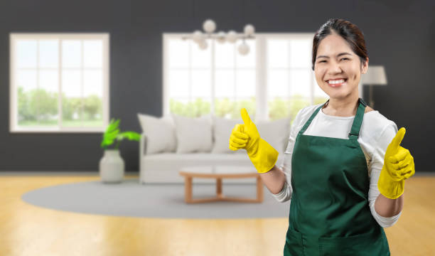 istock Asian housekeeper wear gloves apron 2154664523