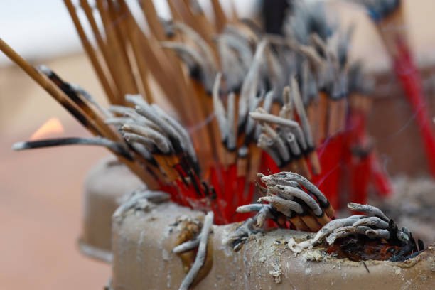 Burning incense sticks in a temple in Thailand. Photo of an incense burner