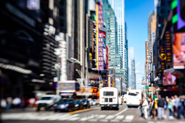 The crowds and the colorful billboards at the modern buildigns in Times Square, Manhattan, New York City distorted by the lensaby lens.