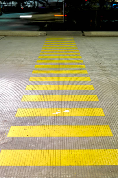 istock Yellow pedestrian crossing on concrete road during the night. 2154681209