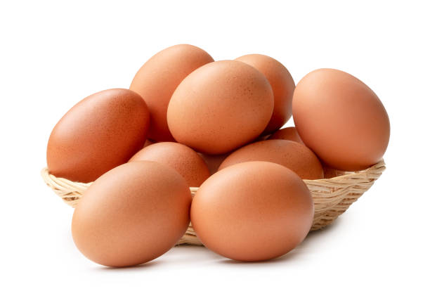 istock Side view of brown chicken eggs in stack in wicker basket isolated on white background 2154682463