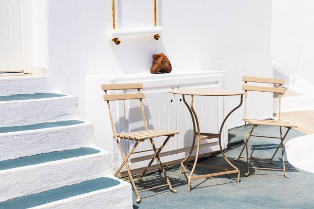 White cycladic architecture in Santorini island, Greece. Two chairs with table on the terrace