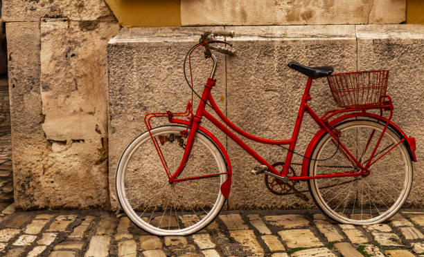 istock Old bicycle leaning against the wall, damaged bicycle tire 2154687118