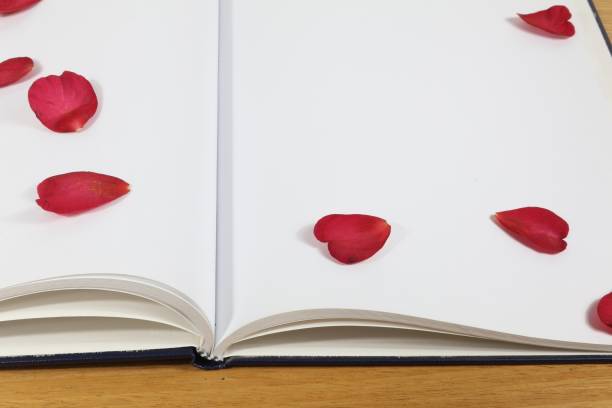 istock Diary with white sheet and red flower petals 2154687358